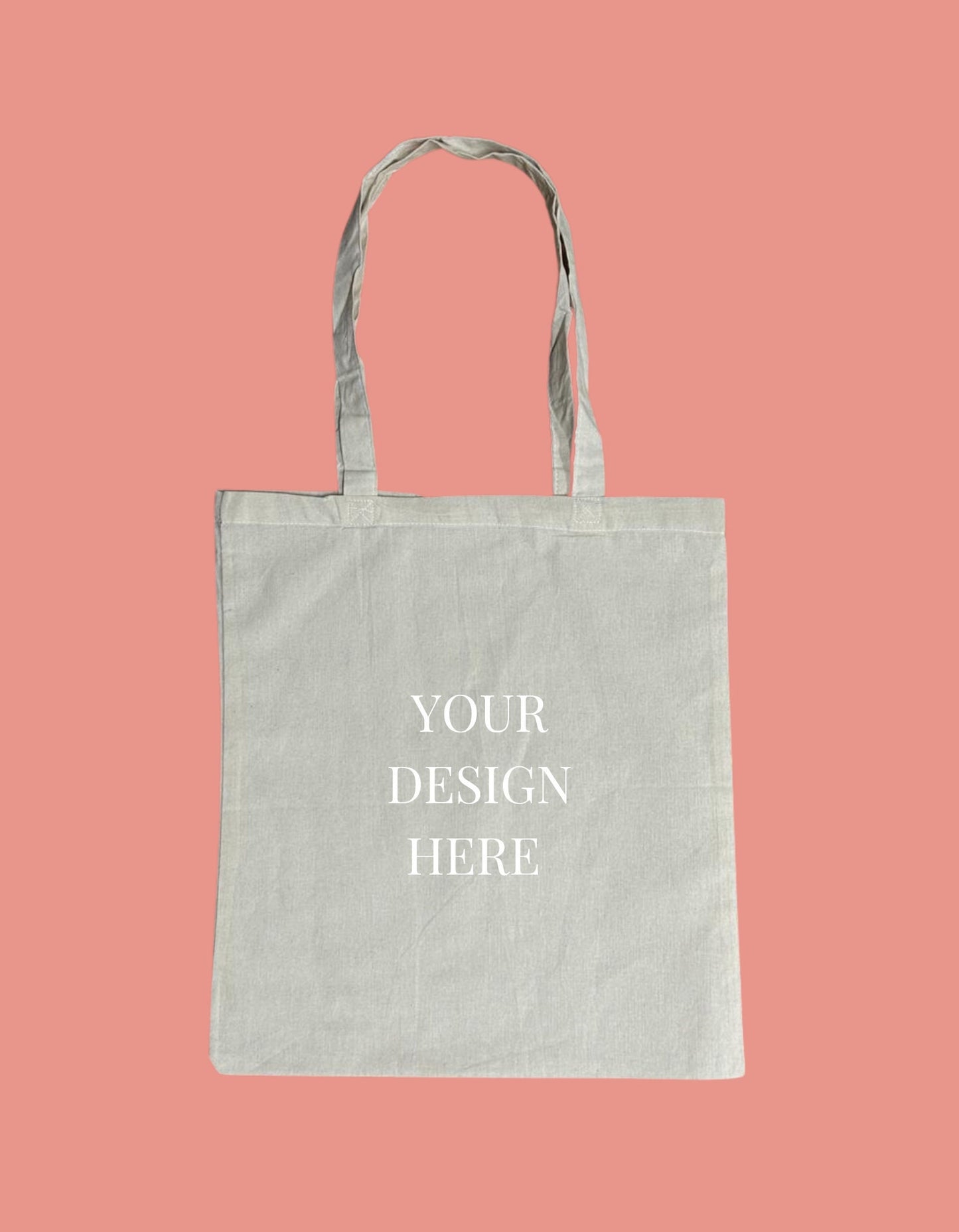a tote bag mockup on a pink background