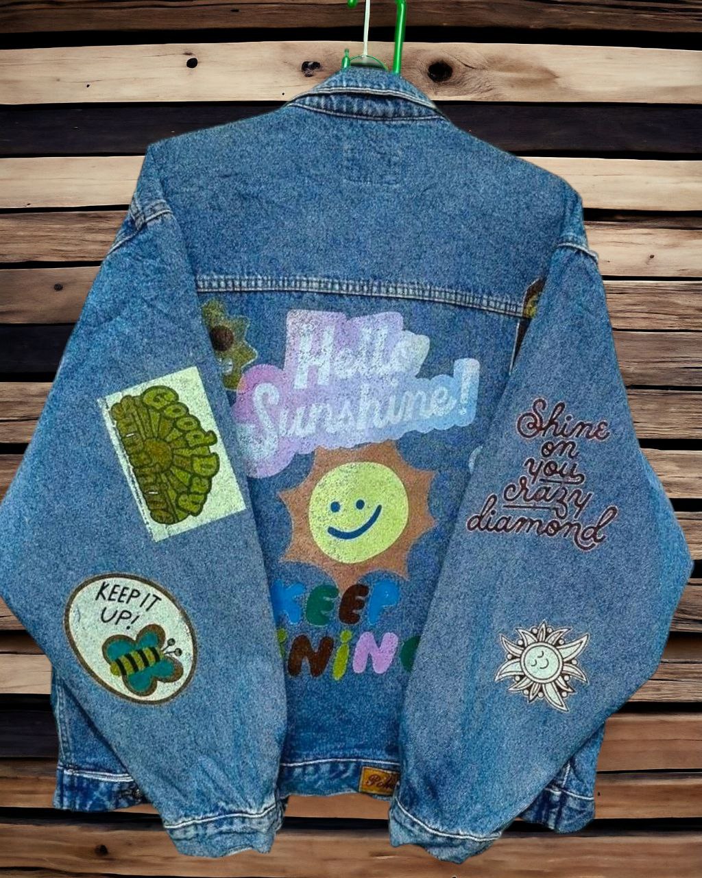 a denim jacket with pictures of  letters and expressions printed on it