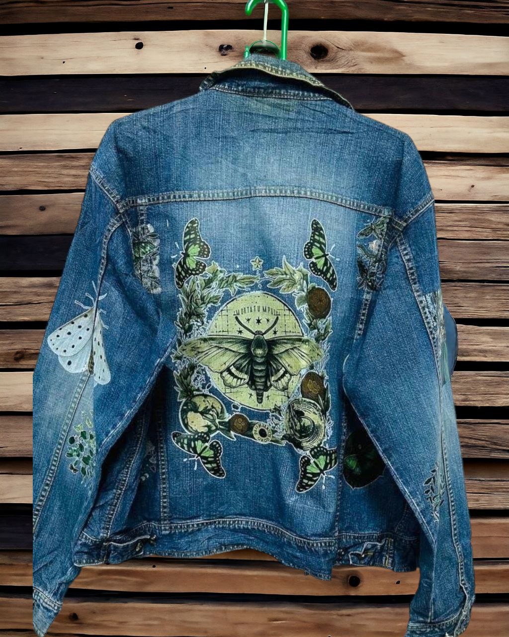 a denim jacket with pictures of bohemian moth printed on it