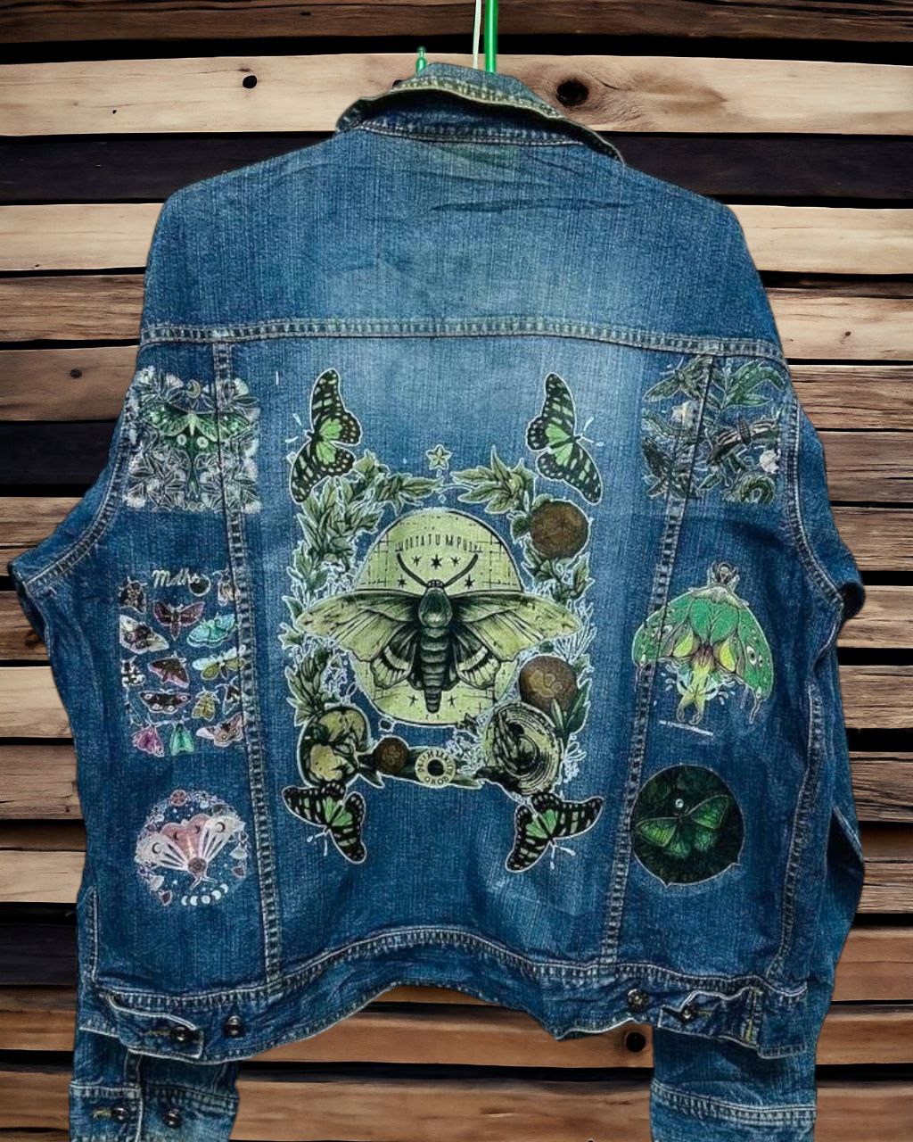 a denim jacket with pictures of bohemian moth printed on it