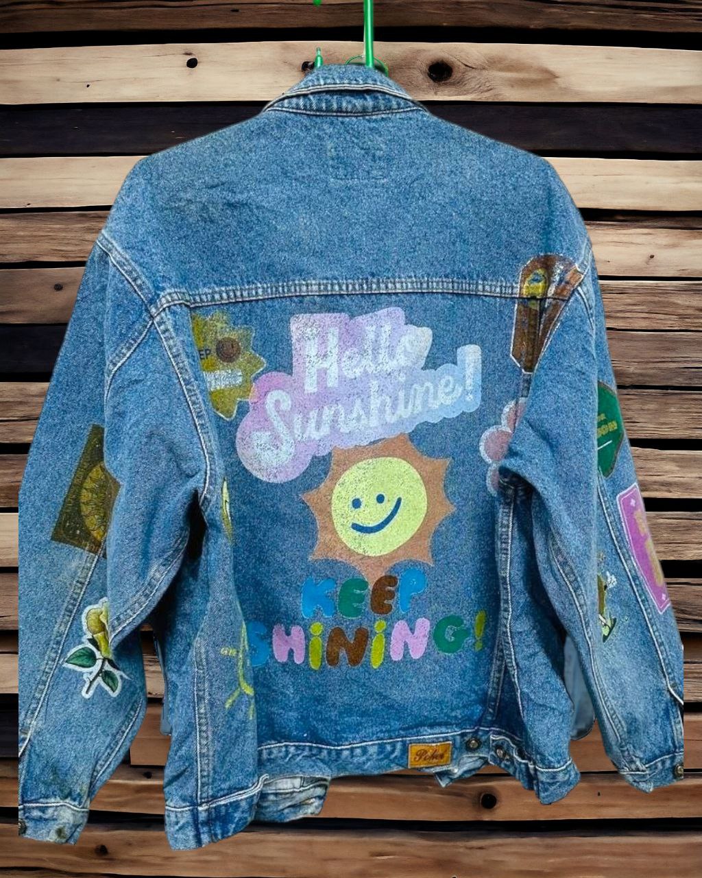 a denim jacket with pictures of  letters and expressions printed on it