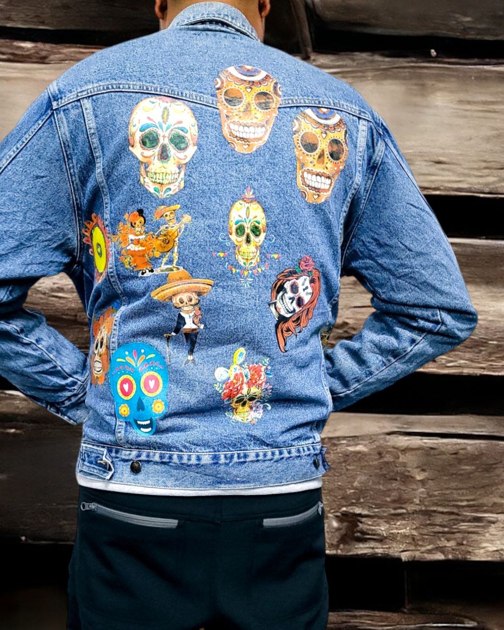 a denim jacket with pictures of sugarskull printed on it