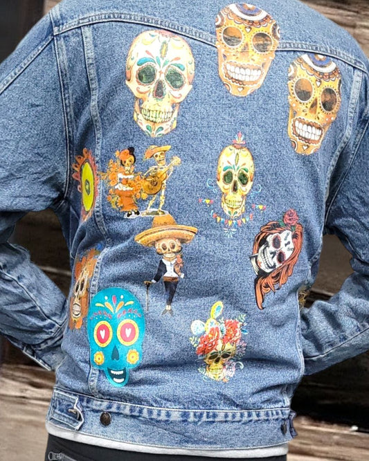 a denim jacket with pictures of sugarskull printed on it