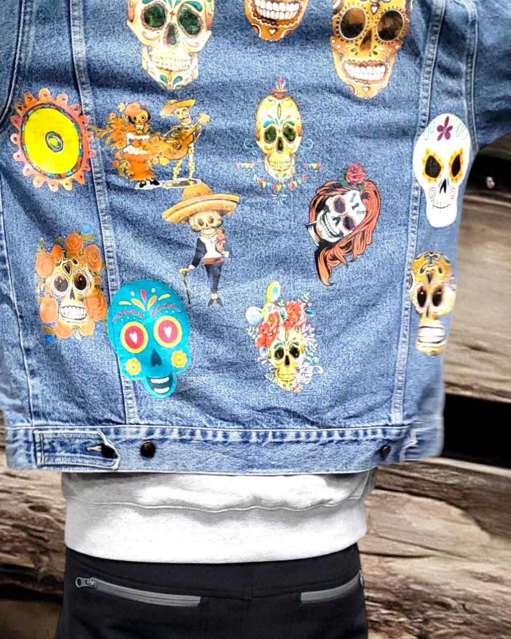 a denim jacket with pictures of sugarskull printed on it