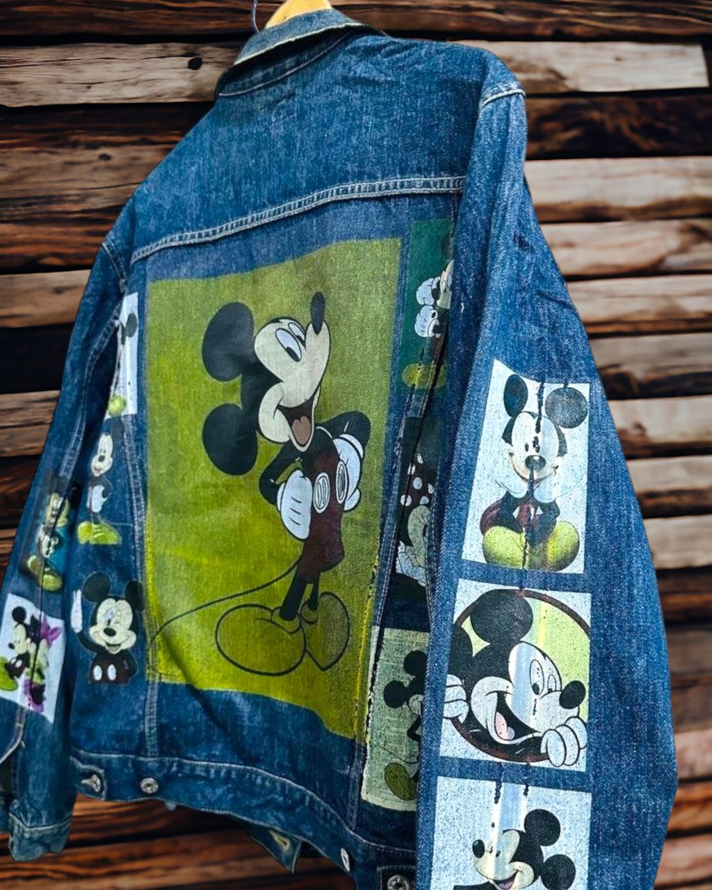 a picture of mickey mouse printed on a denim jacket 