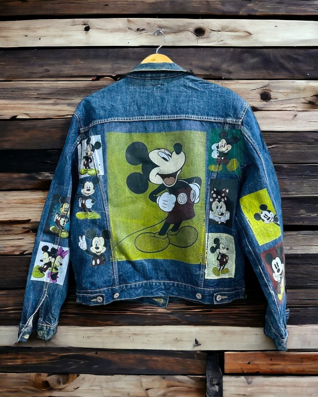 a picture of mickey mouse printed on a denim jacket 