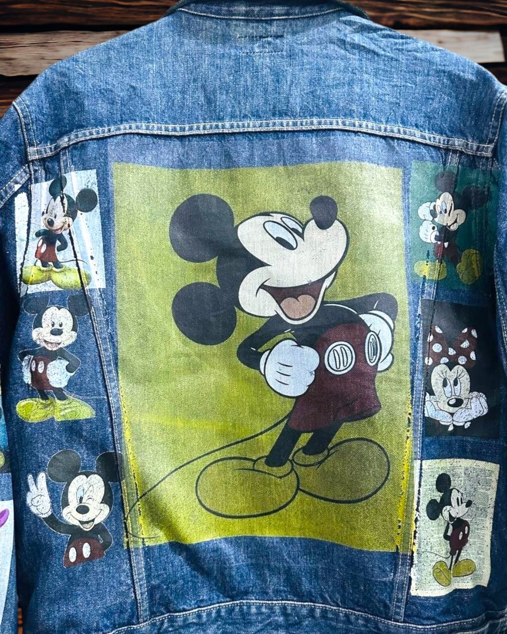 a picture of mickey mouse printed on a denim jacket 