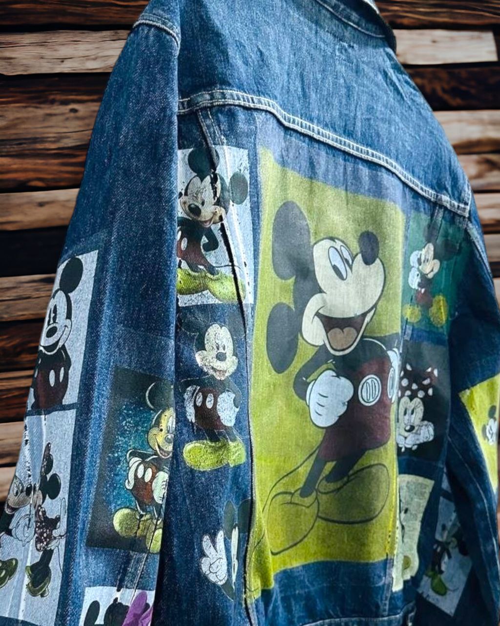 a picture of mickey mouse printed on a denim jacket 