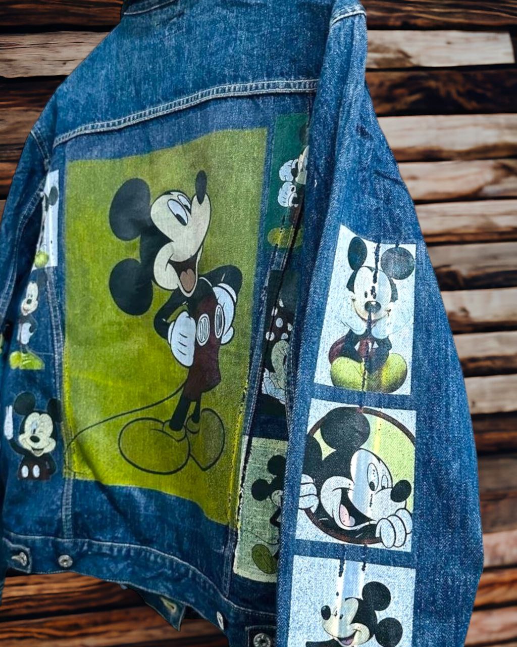 a picture of mickey mouse printed on a denim jacket 