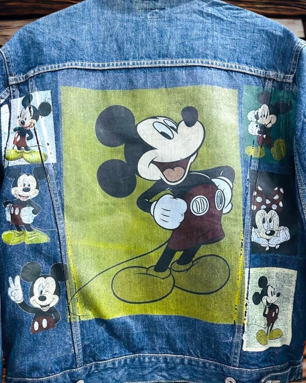 a picture of mickey mouse printed on a denim jacket 