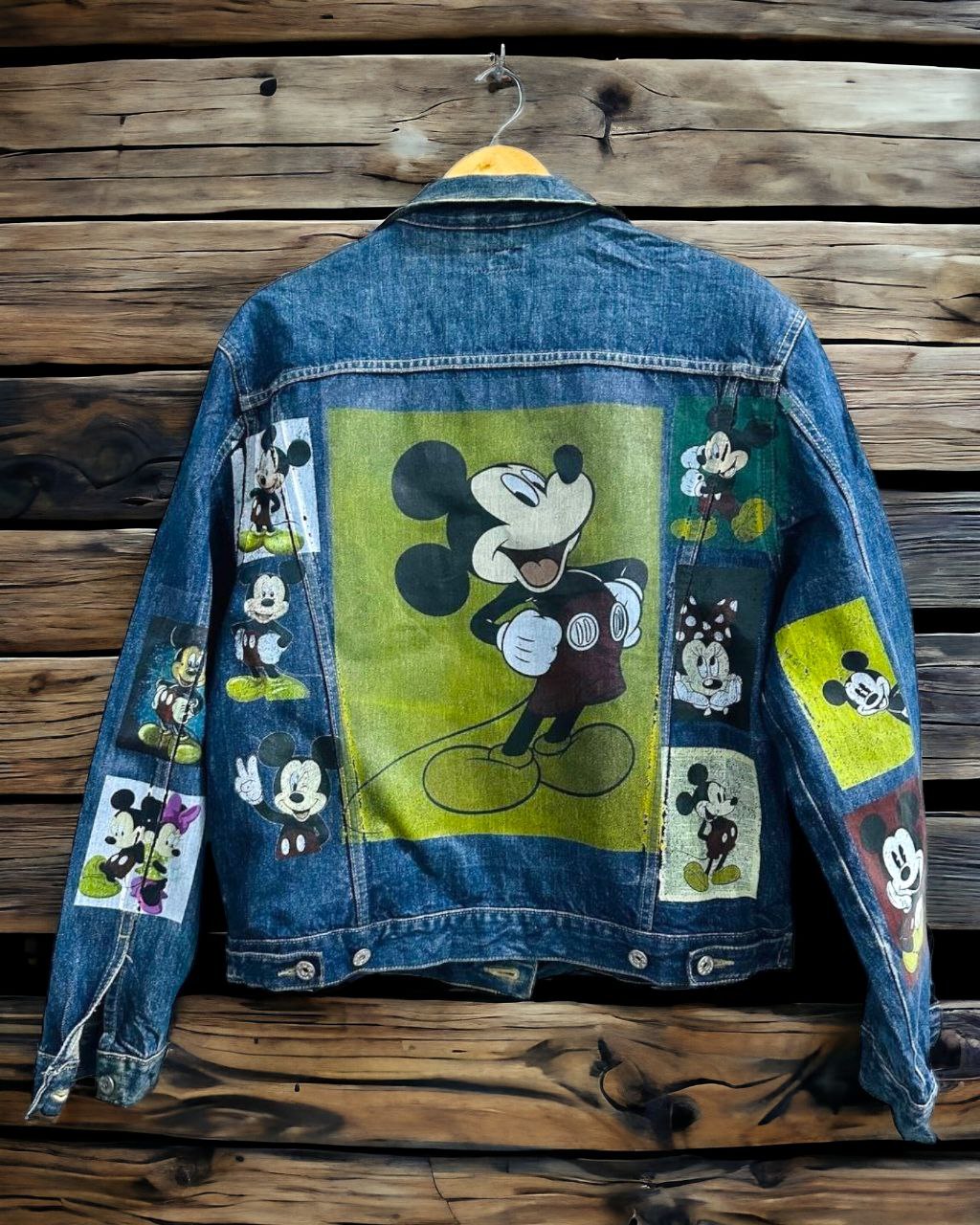 a picture of mickey mouse printed on a denim jacket 