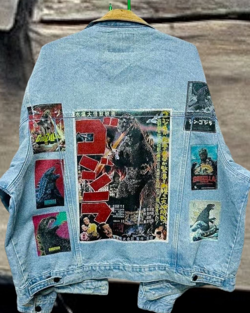 a denim jacket with pictures of japanese godzilla printed on it