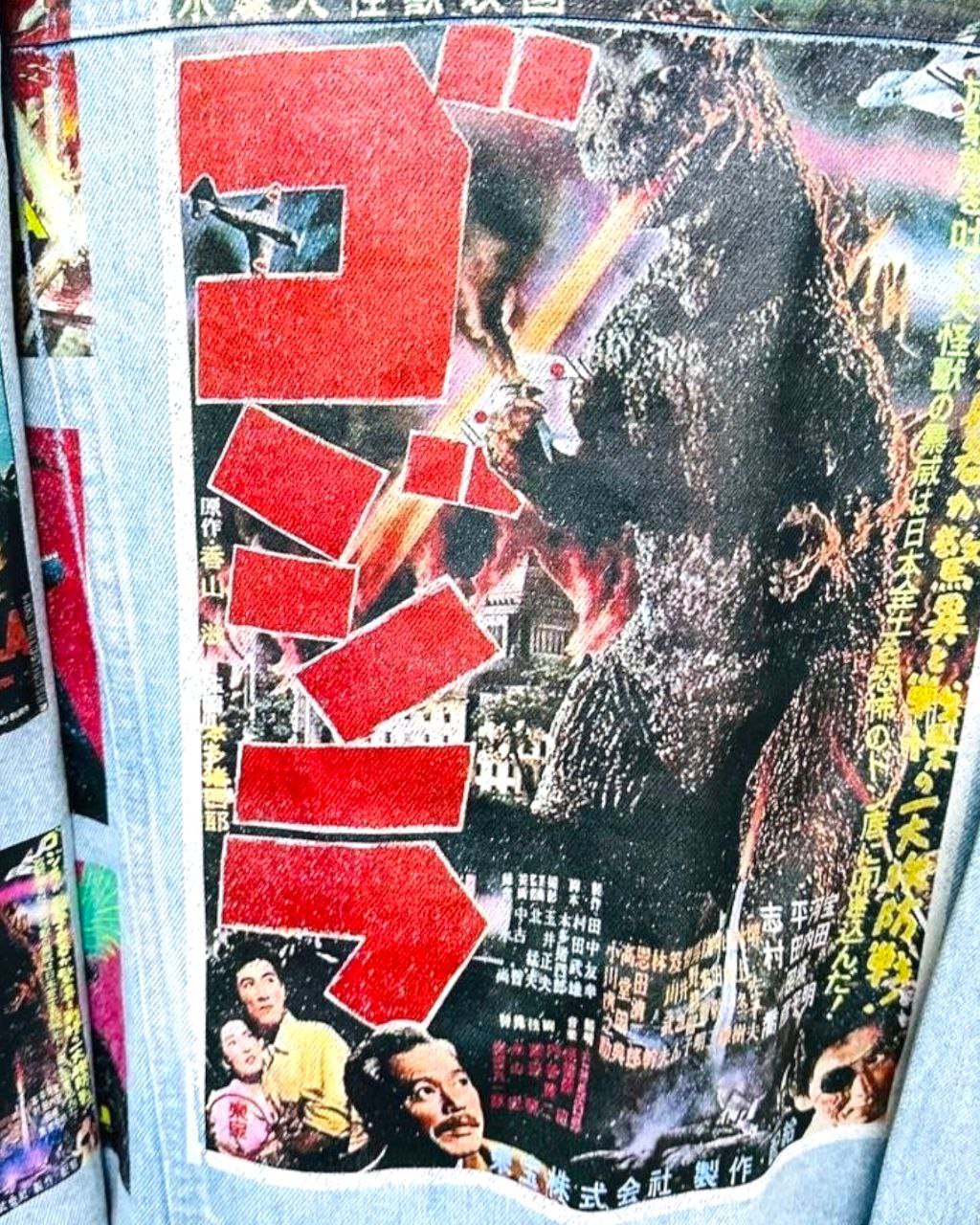 a denim jacket with pictures of japanese godzilla printed on it