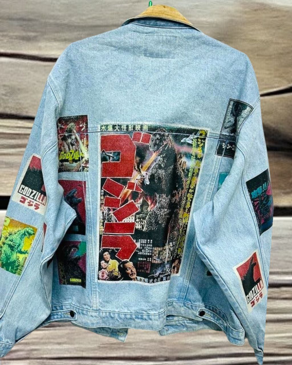 a denim jacket with pictures of japanese godzilla printed on it