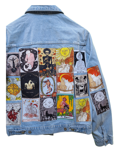 Denim jacket with tarot card designs on a white background