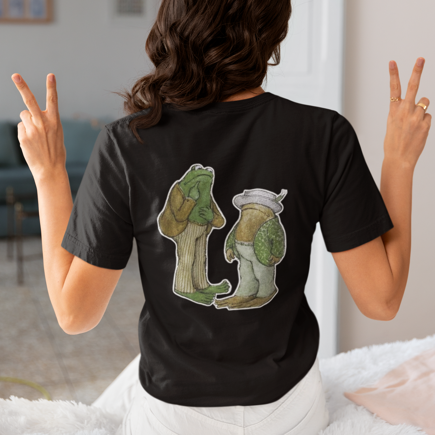 a woman wearing a black frog and toad  t - shirt