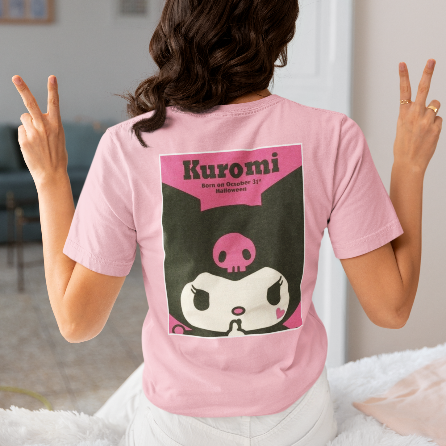 a woman wearing a pink Kuromi Hello Kitty T-shirt