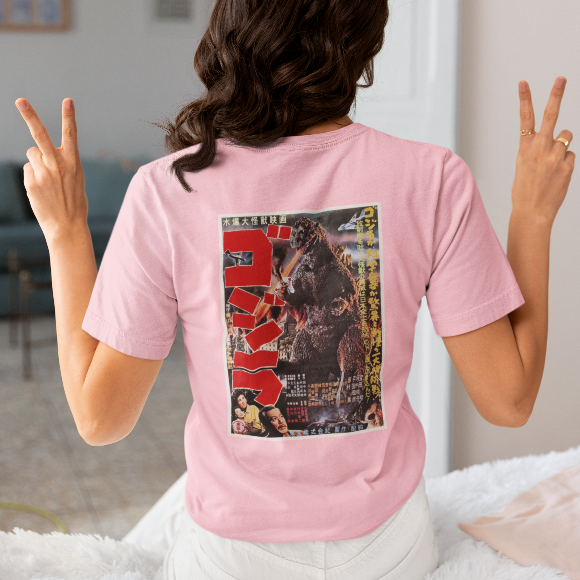 a woman wearing a pink japanese godzilla  t - shirt