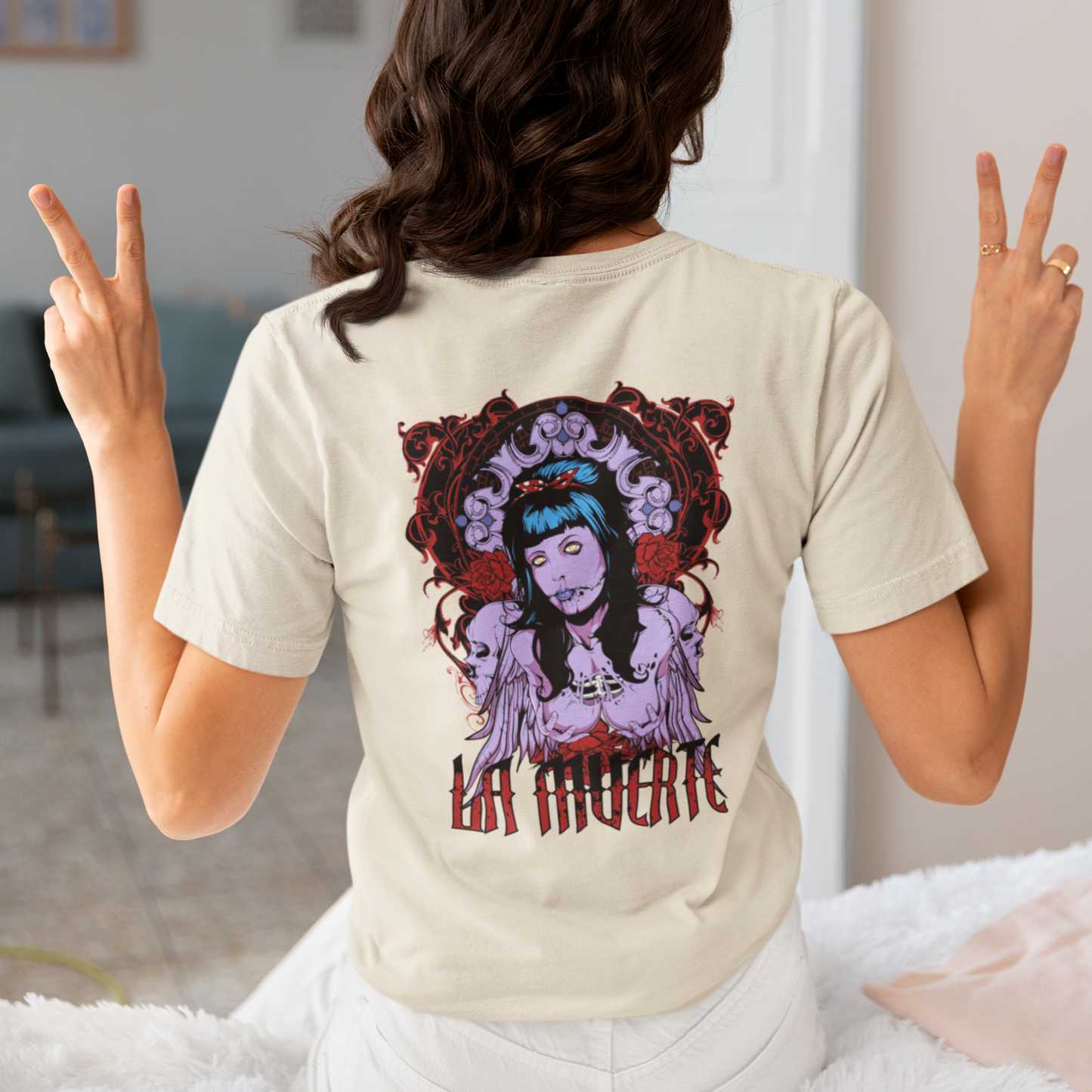 a woman wearing a white La Muerte T-shirt