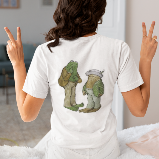 a woman wearing a white frog and toad  t - shirt