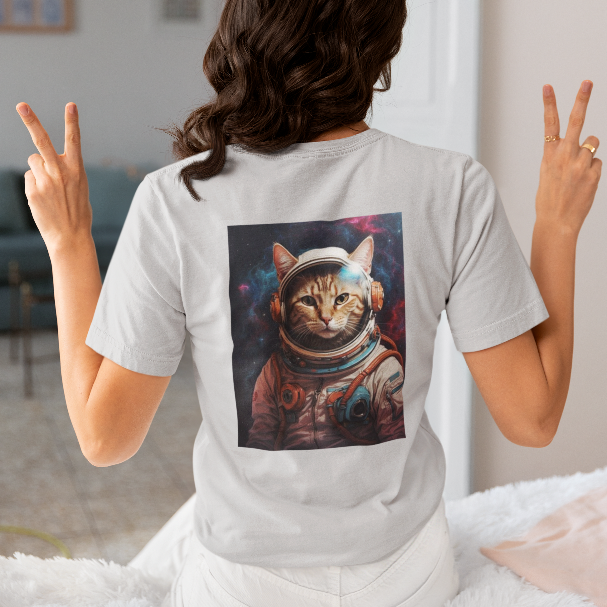 a woman wearing a grey space cat T-shirt