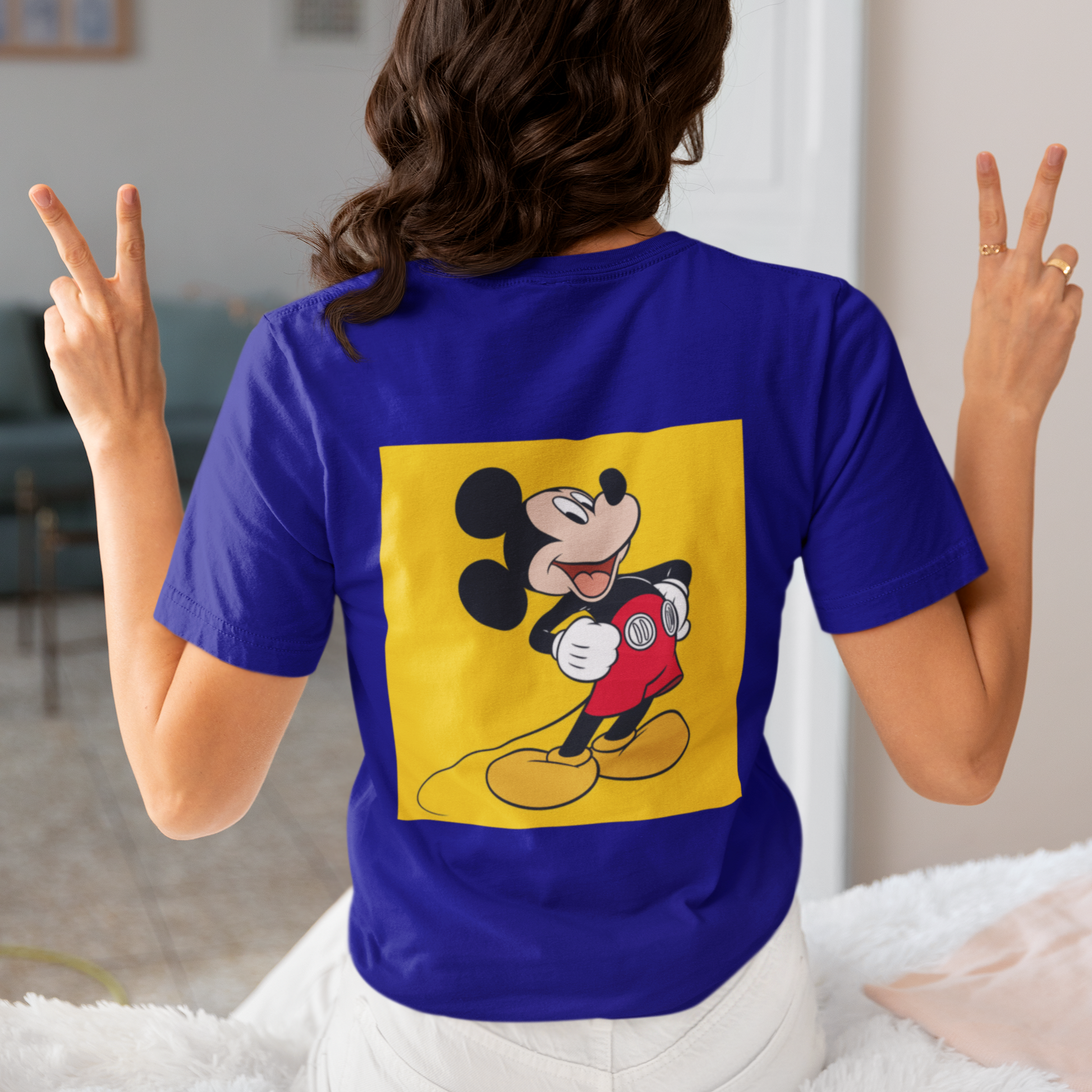 a woman wearing a blue Mickey mouse T-shirt