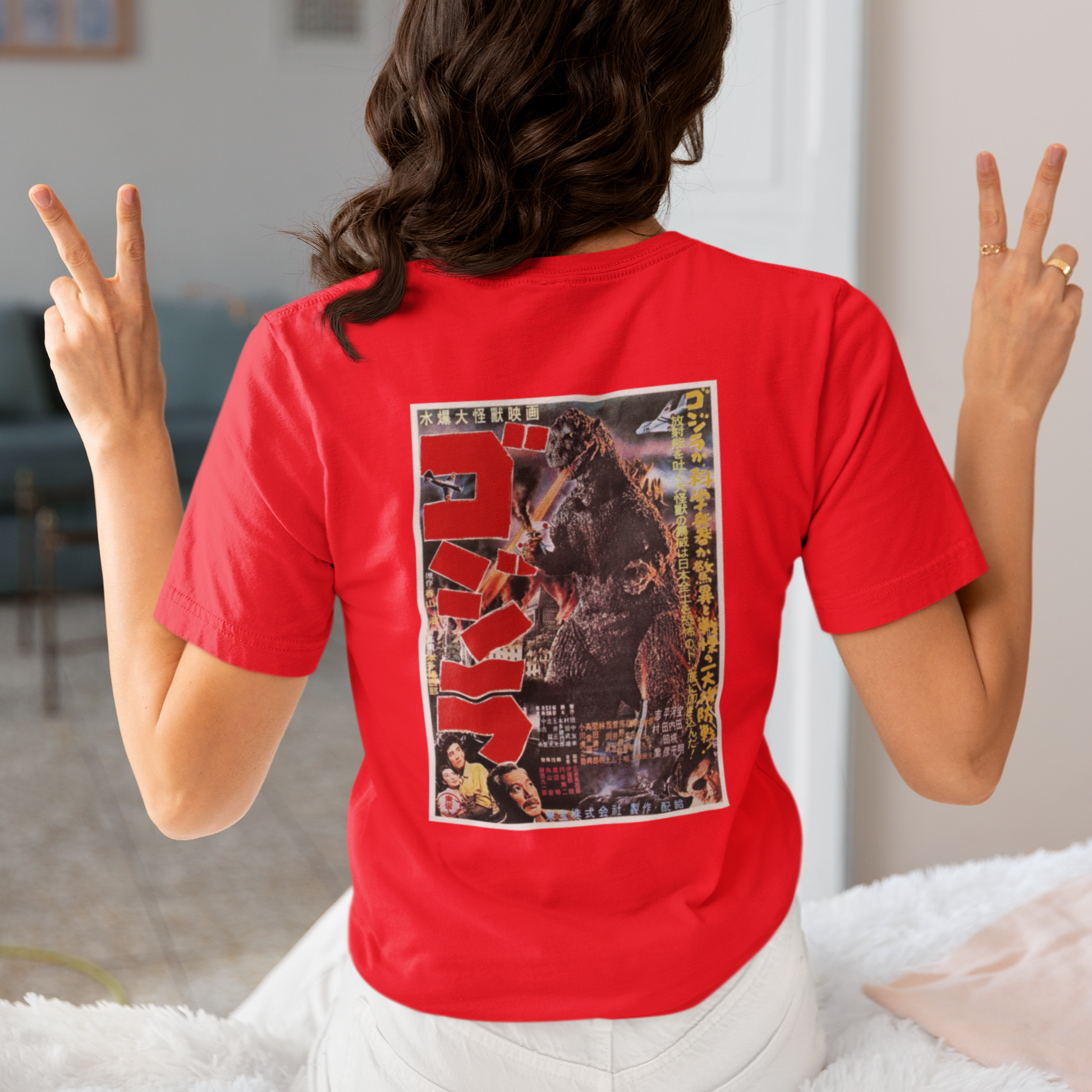 a woman wearing a red japanese godzilla  t - shirt