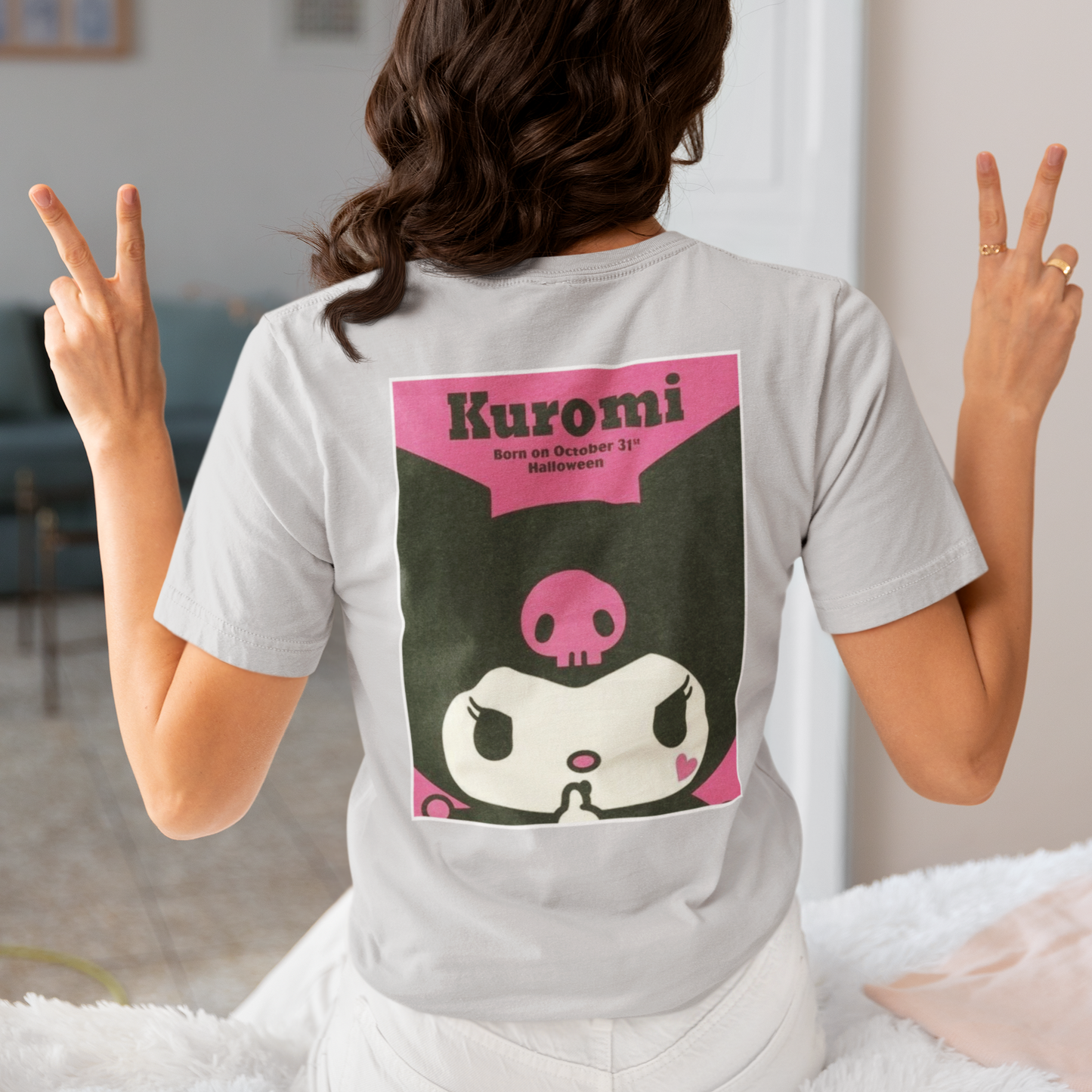 a woman wearing a grey Kuromi Hello Kitty T-shirt