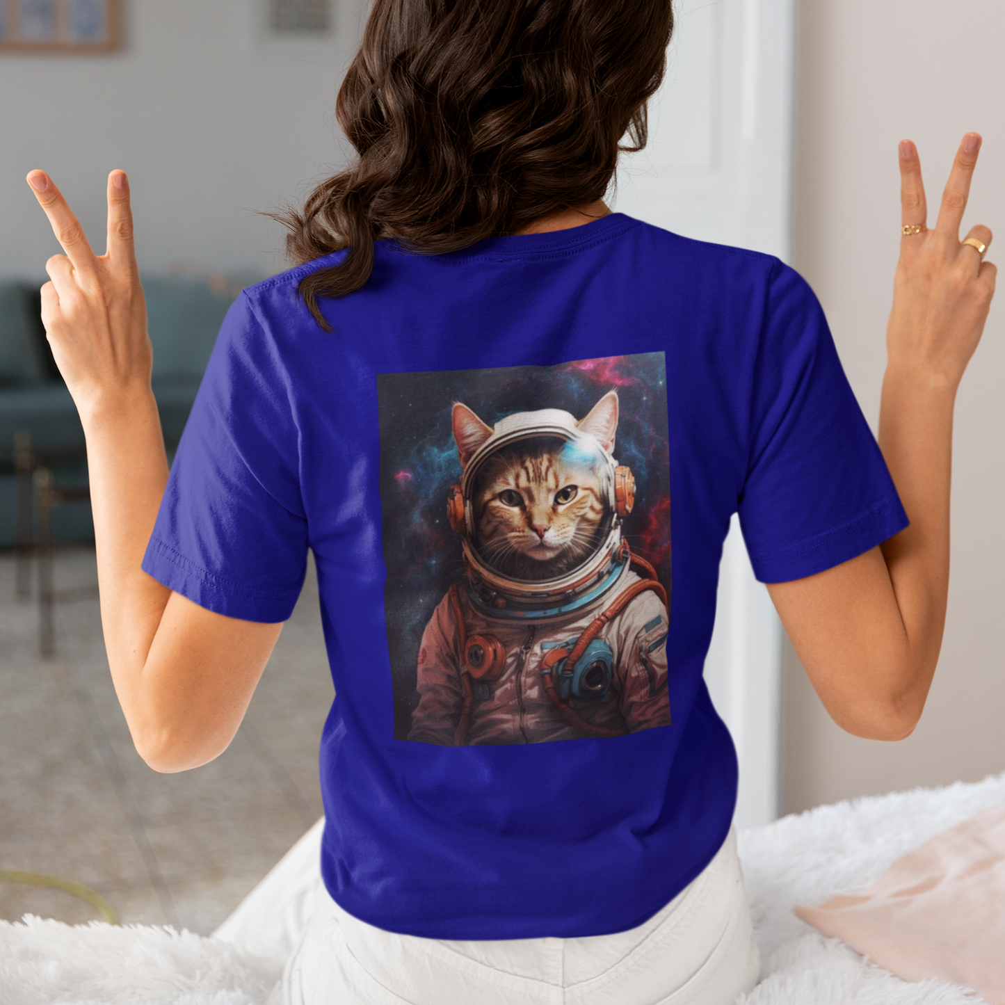 a woman wearing a blue space cat T-shirt