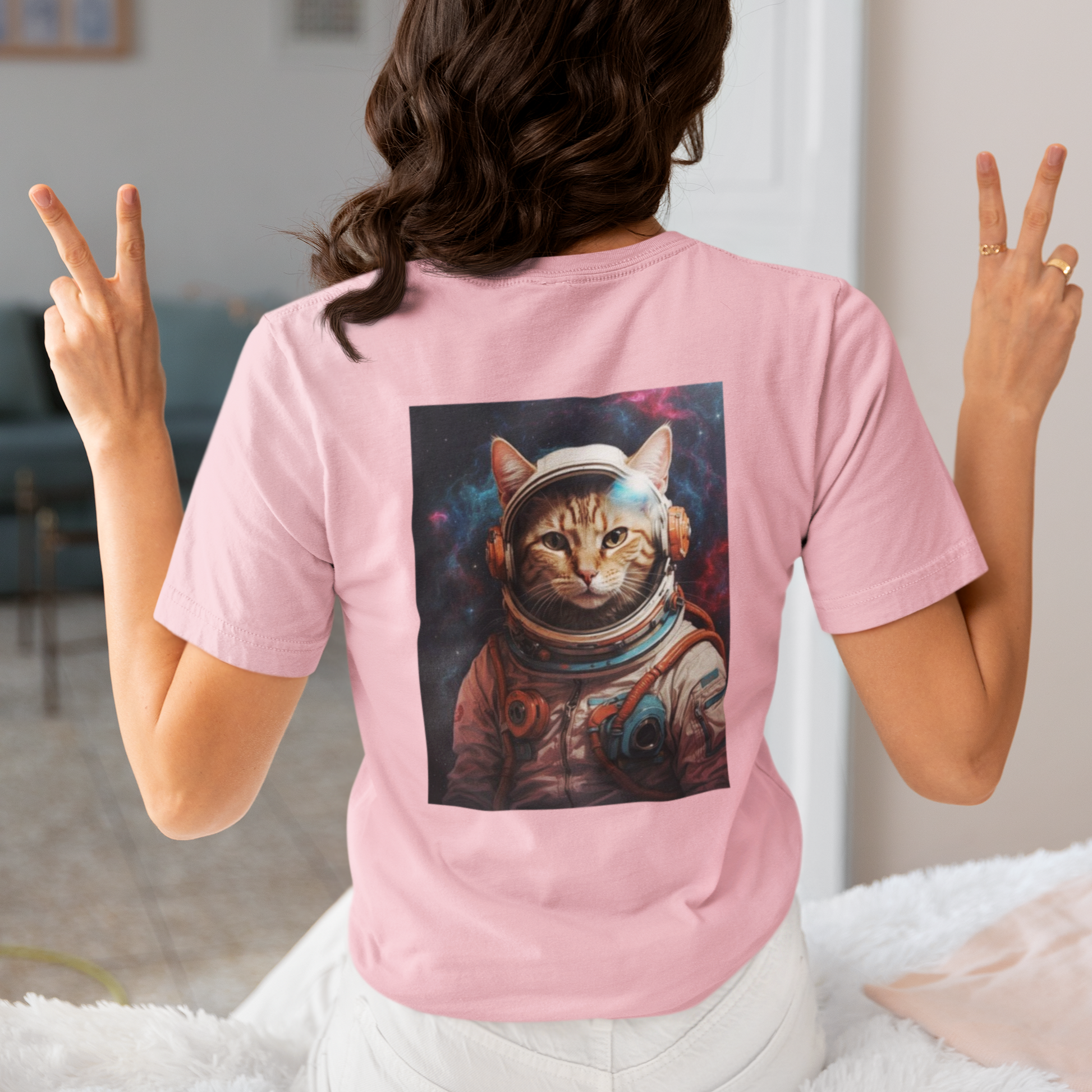 a woman wearing a pink space cat T-shirt