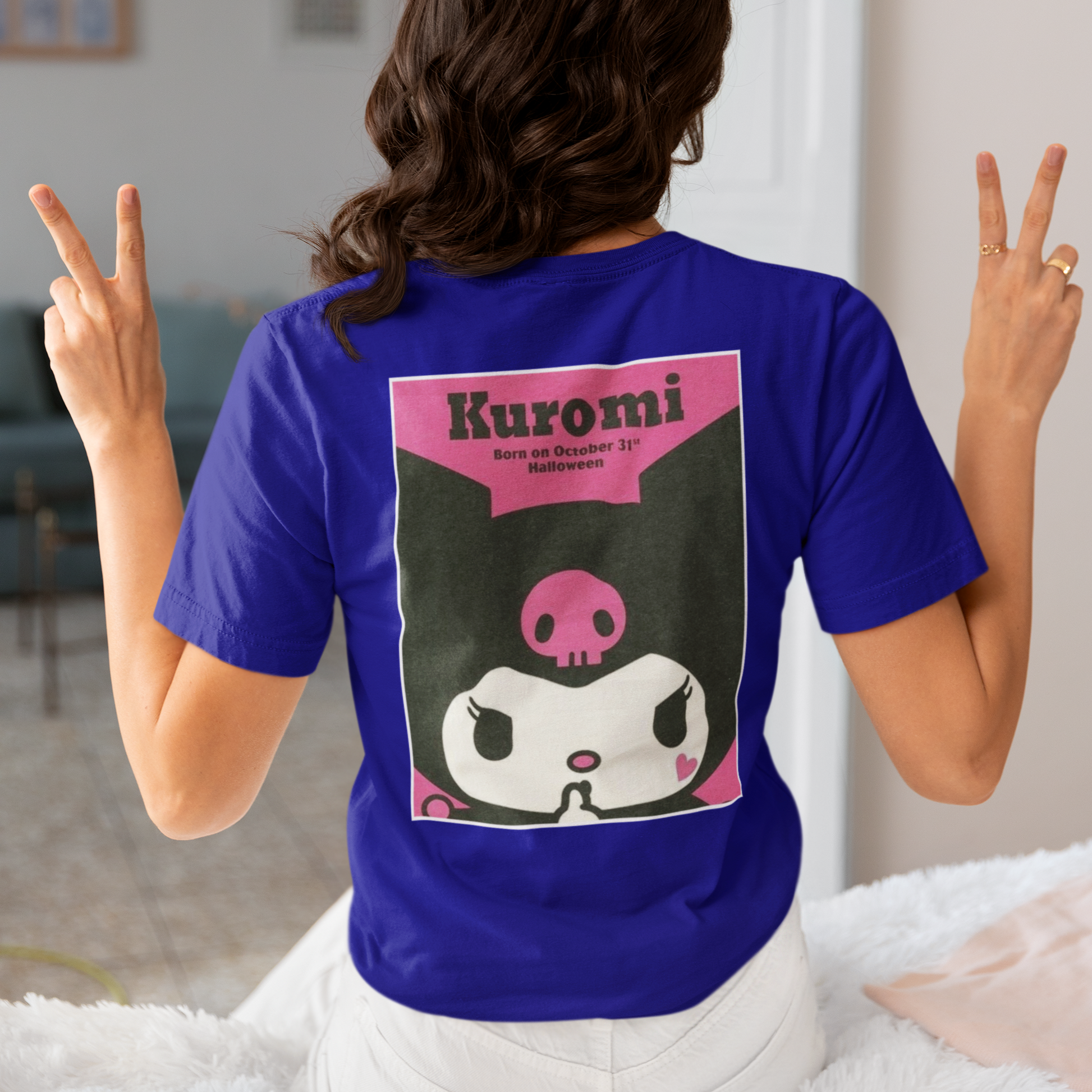 a woman wearing a blue Kuromi Hello Kitty T-shirt