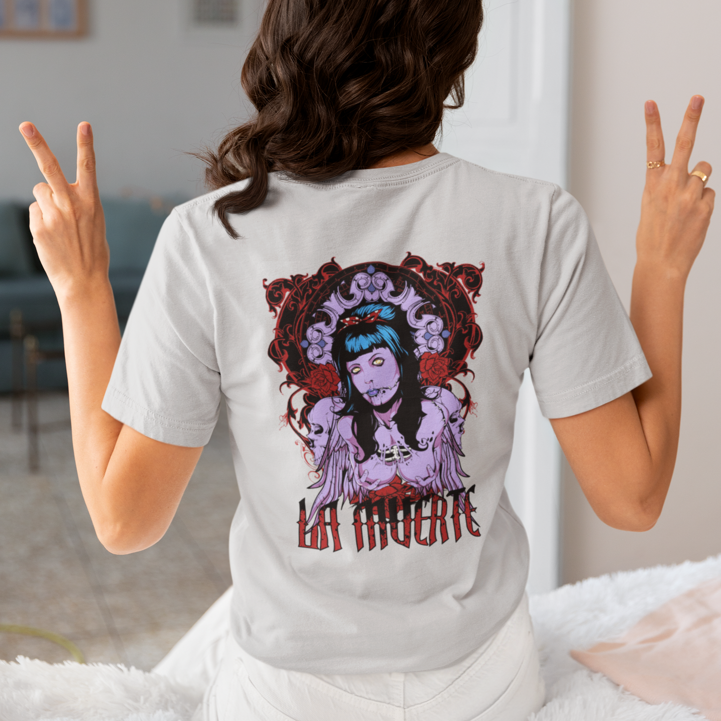 a woman wearing a grey La Muerte T-shirt