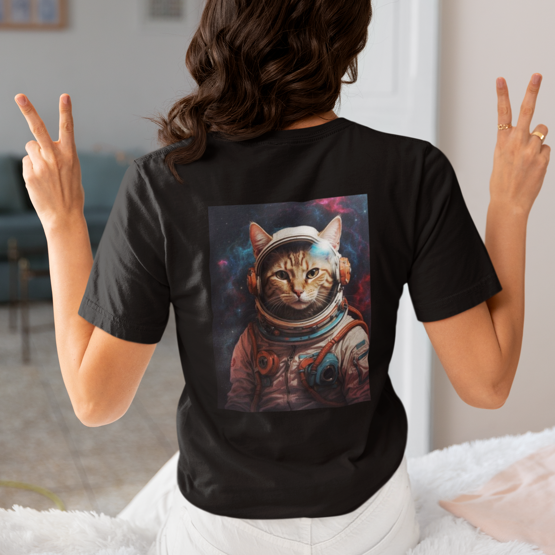 a woman wearing a black space cat T-shirt