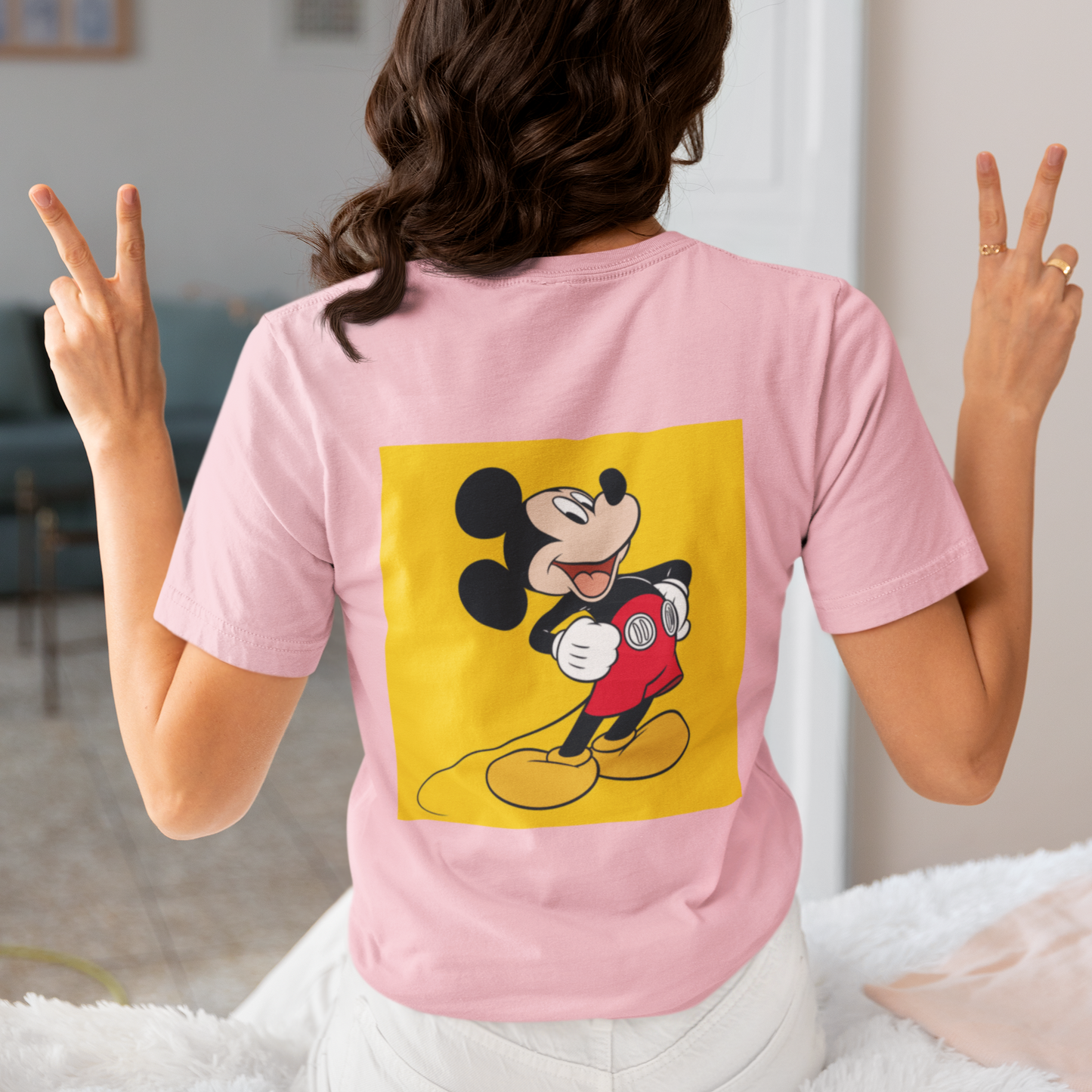 a woman wearing a pink Mickey mouse T-shirt