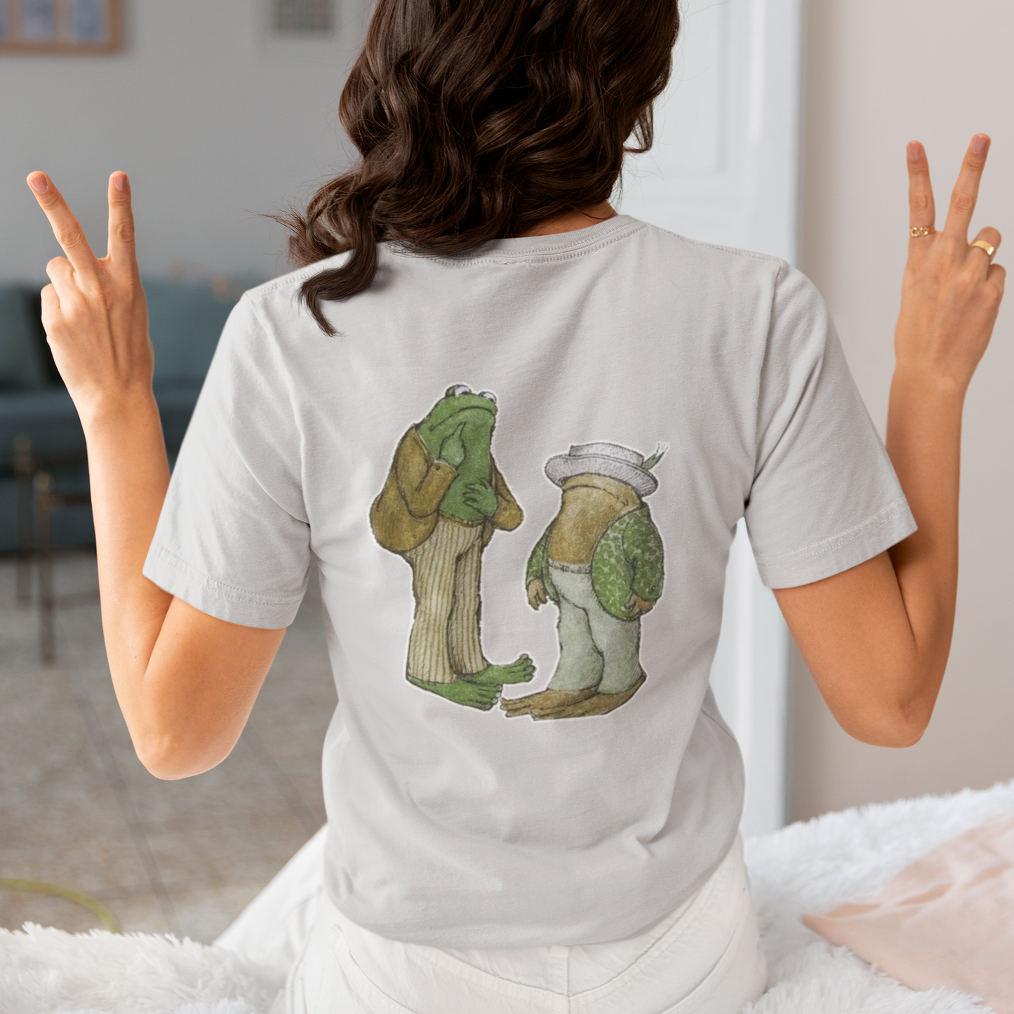 a woman wearing a grey frog and toad  t - shirt