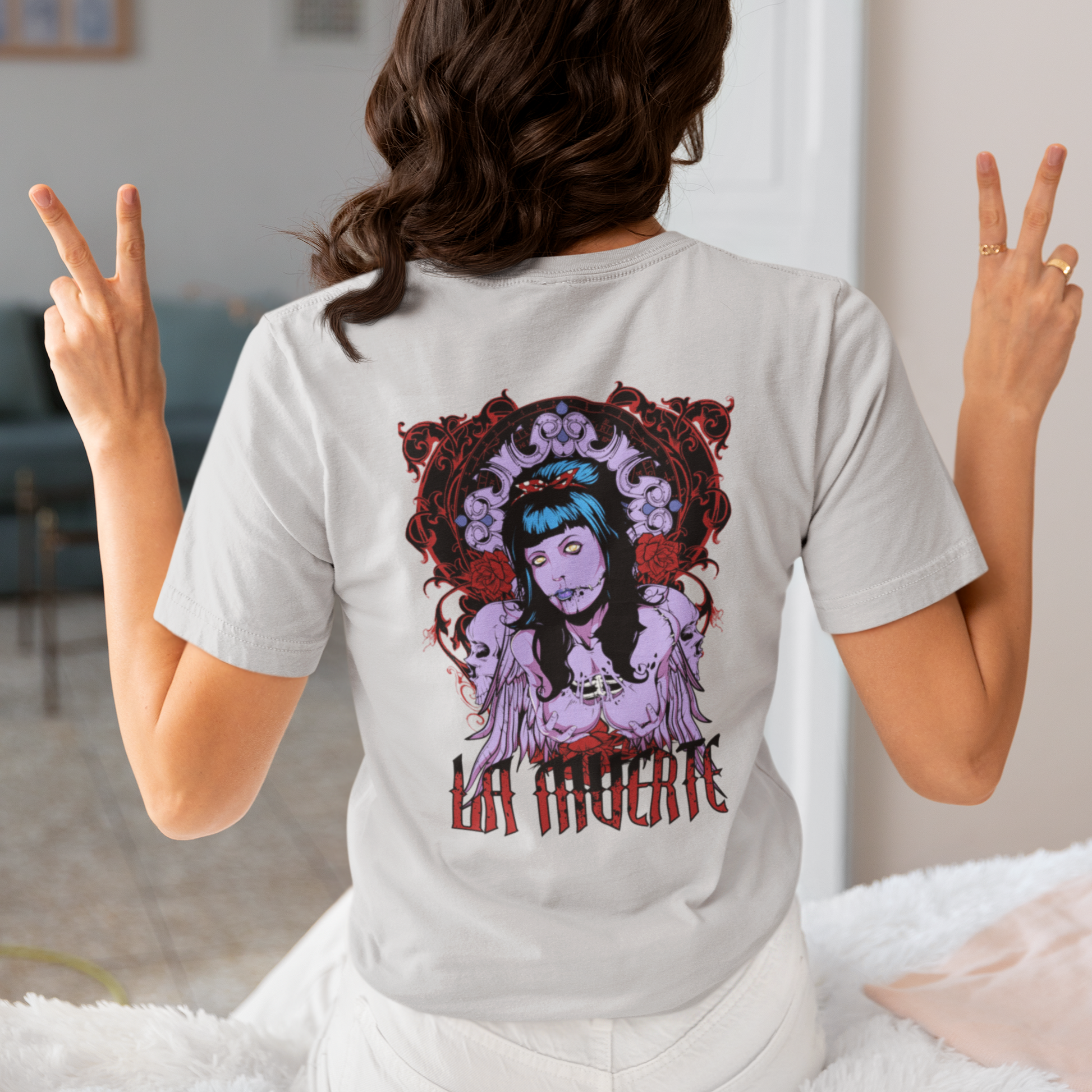 a woman wearing a beige La Muerte T-shirt