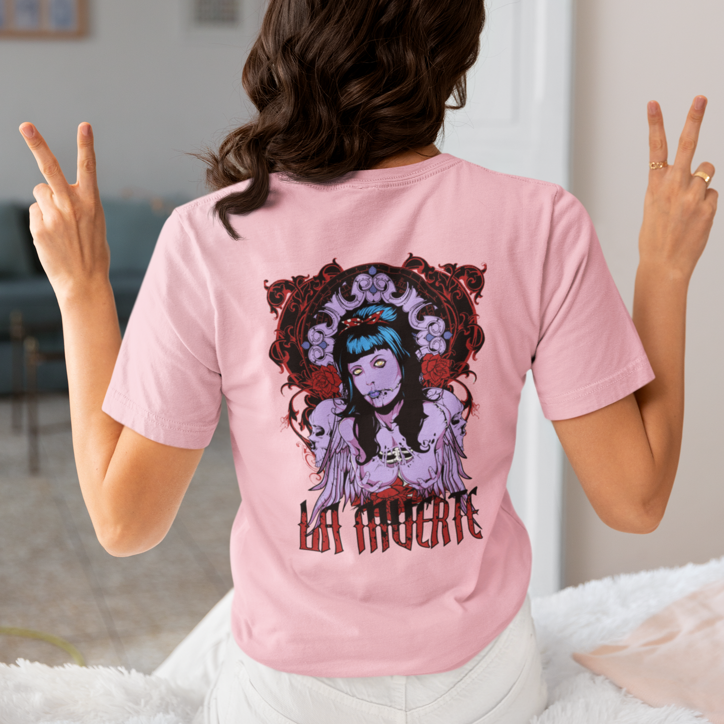 a woman wearing a pink La Muerte T-shirt