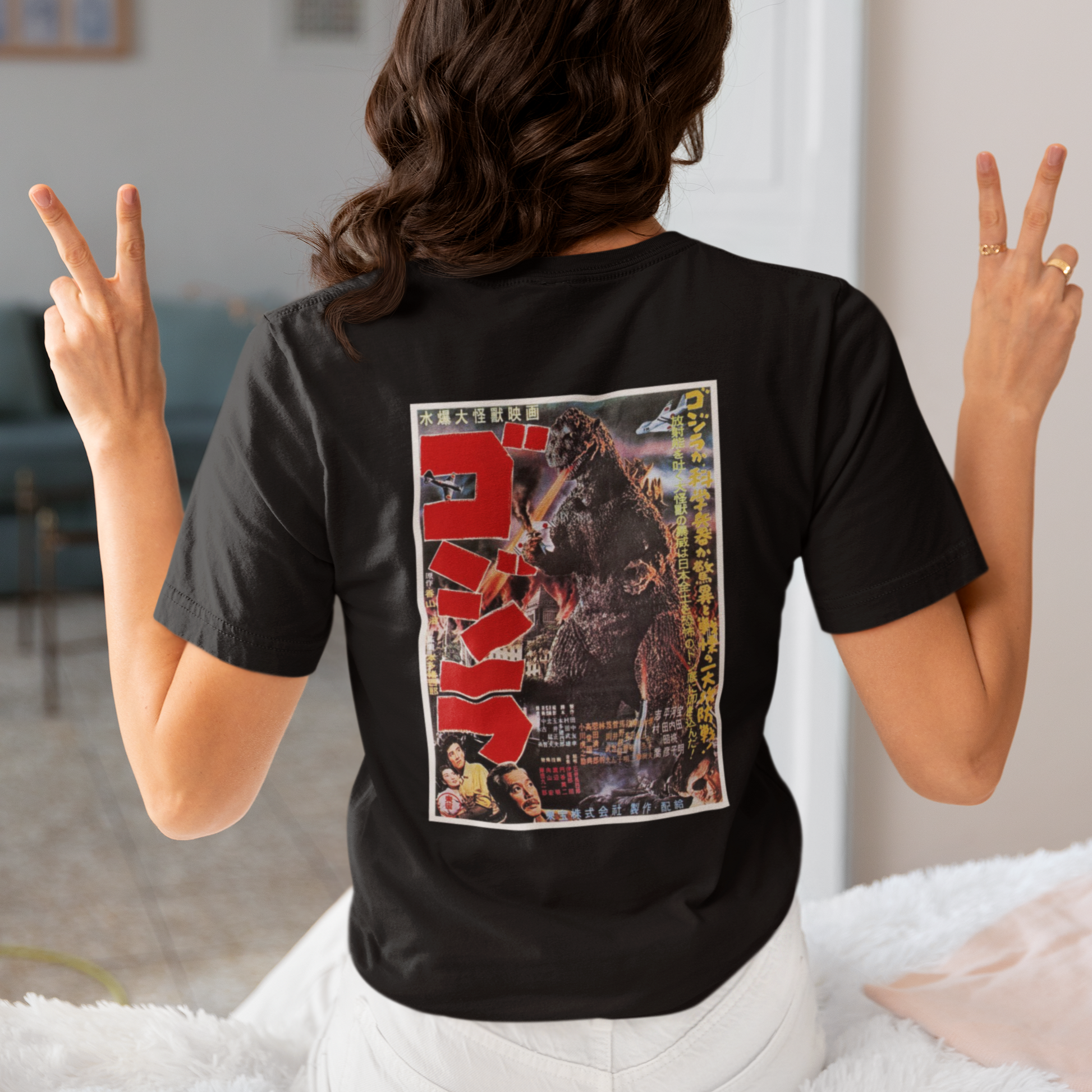 a woman wearing a black japanese godzilla  t - shirt