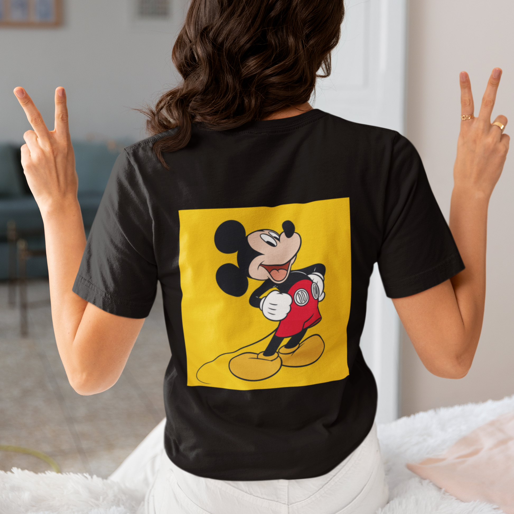 a woman wearing a black Mickey mouse T-shirt