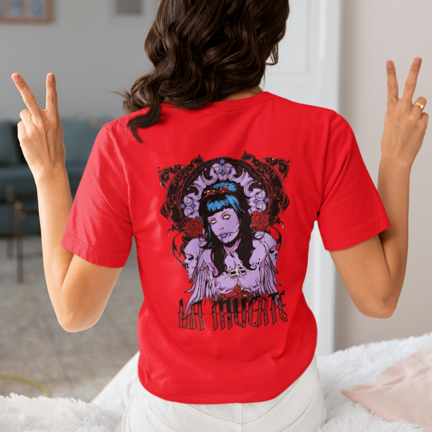 a woman wearing a red La Muerte T-shirt