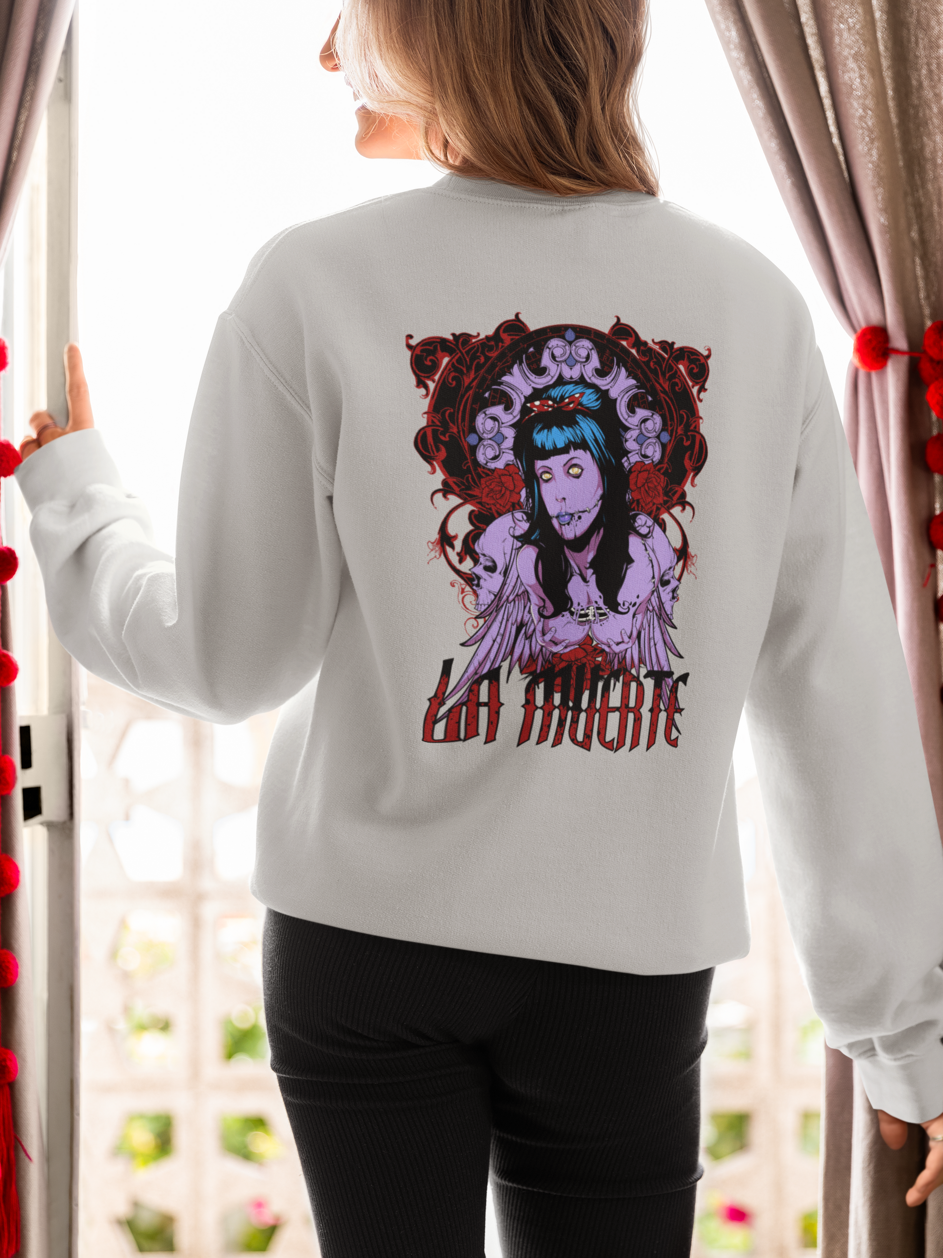 a woman wearing a grey La Muerte sweatshirt