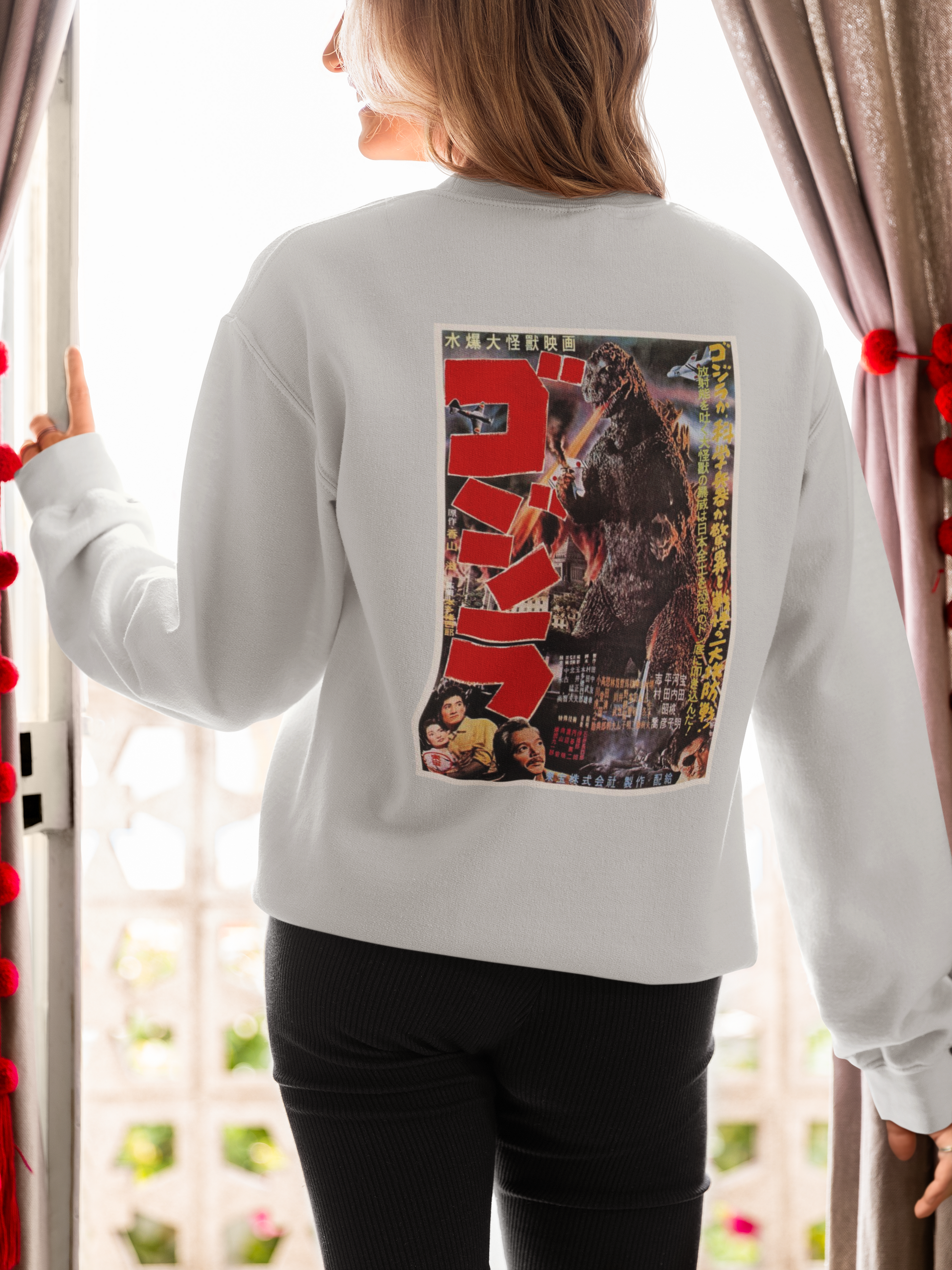 a picture of a woman wearing a grey japanese godzilla  sweatshirt