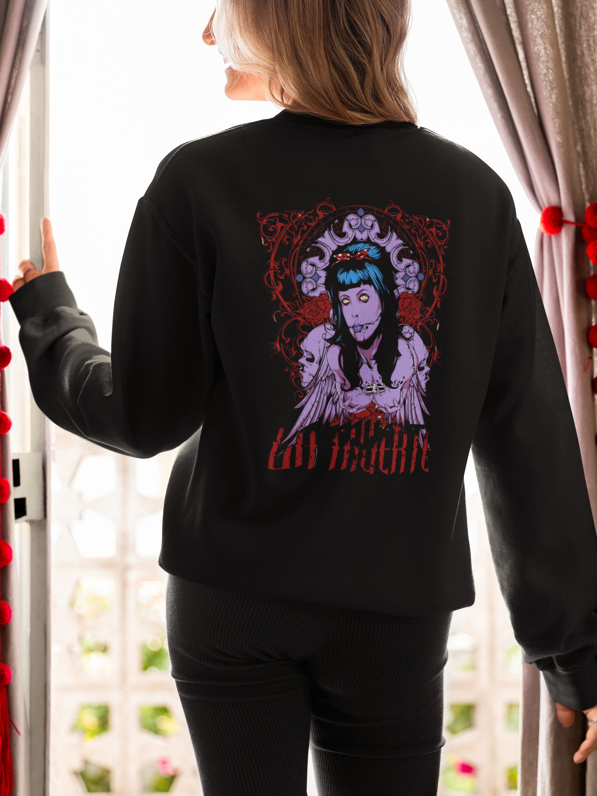 a woman wearing a black La Muerte sweatshirt