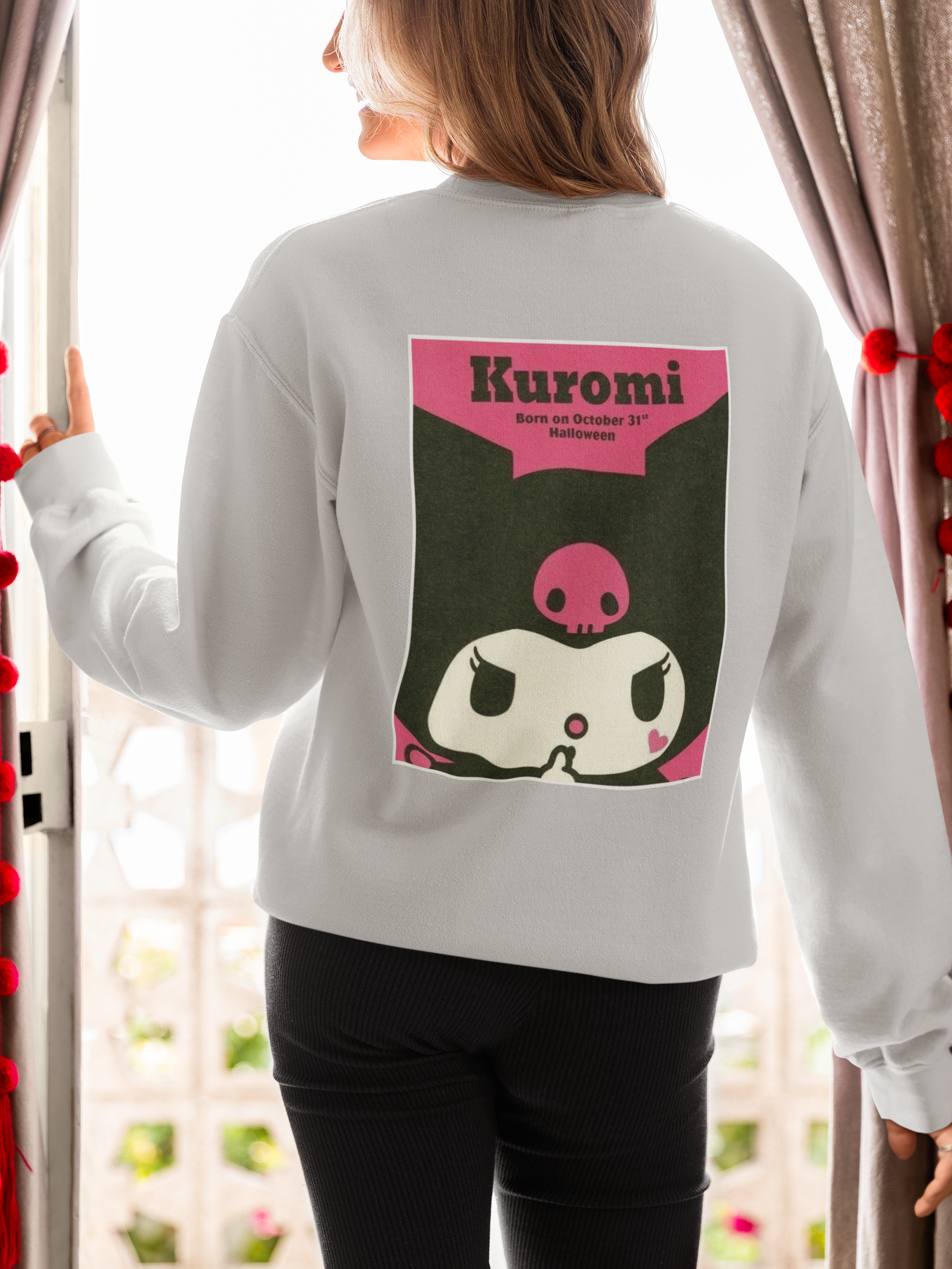 a woman wearing a grey Karumi hello kitty sweatshirt