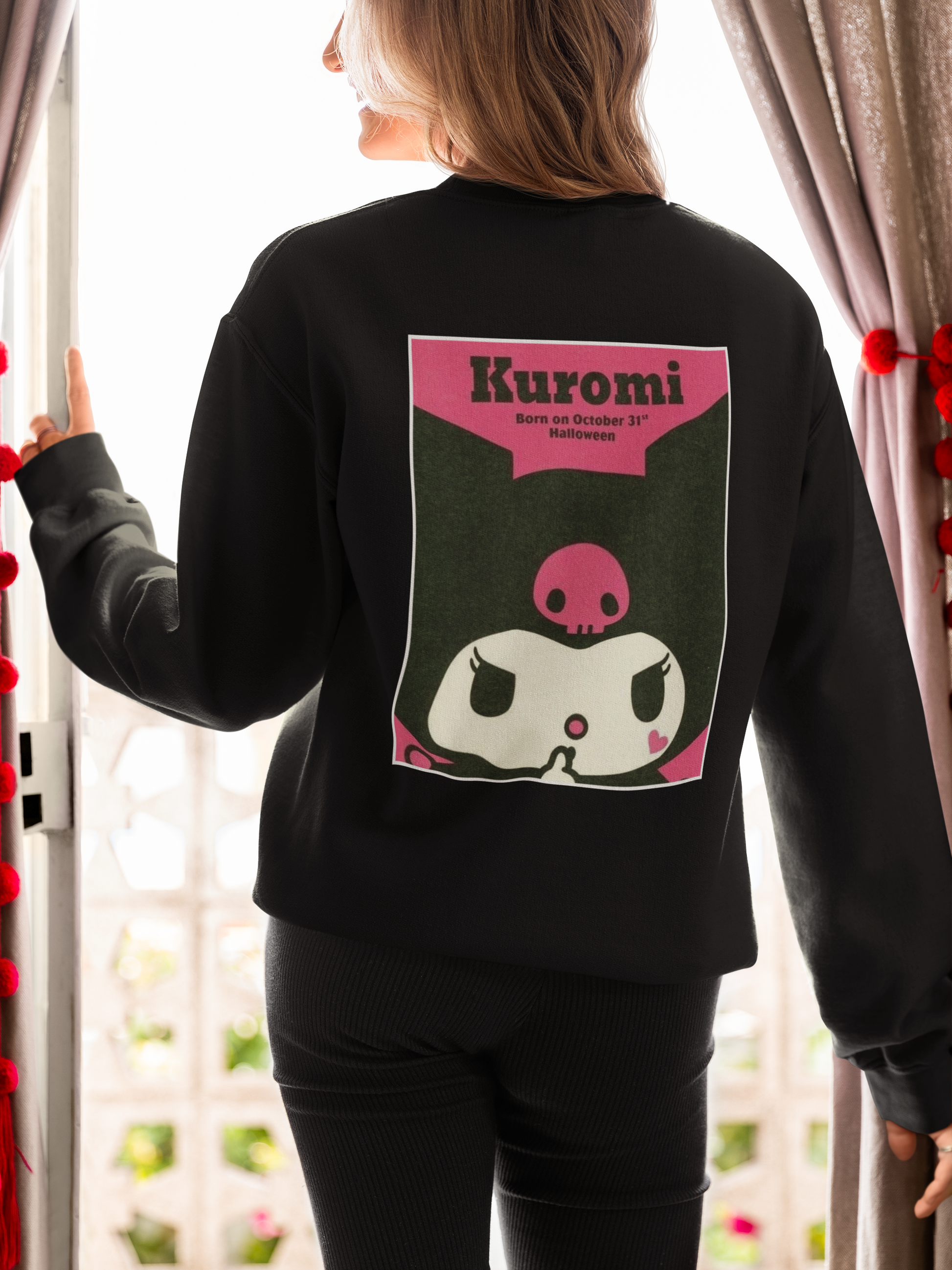 a woman wearing a black Karumi hello kitty sweatshirt