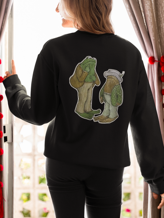 a picture of a woman wearing a black frog and toads sweatshirt