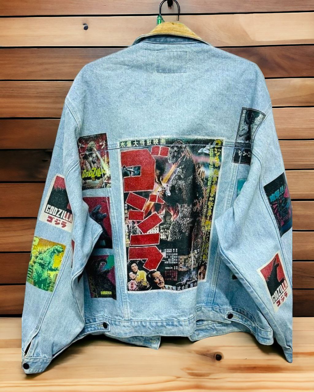 a denim jacket with pictures of japanese godzilla printed on it