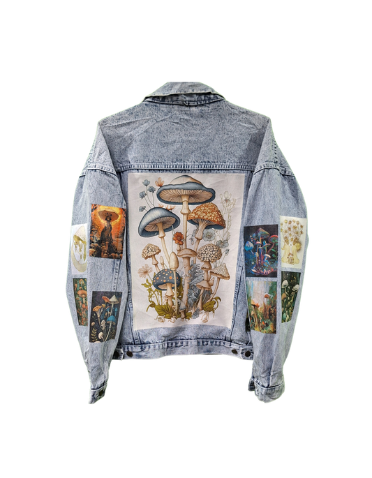 Denim jacket with mushroom and vintage-style patch design on a white background