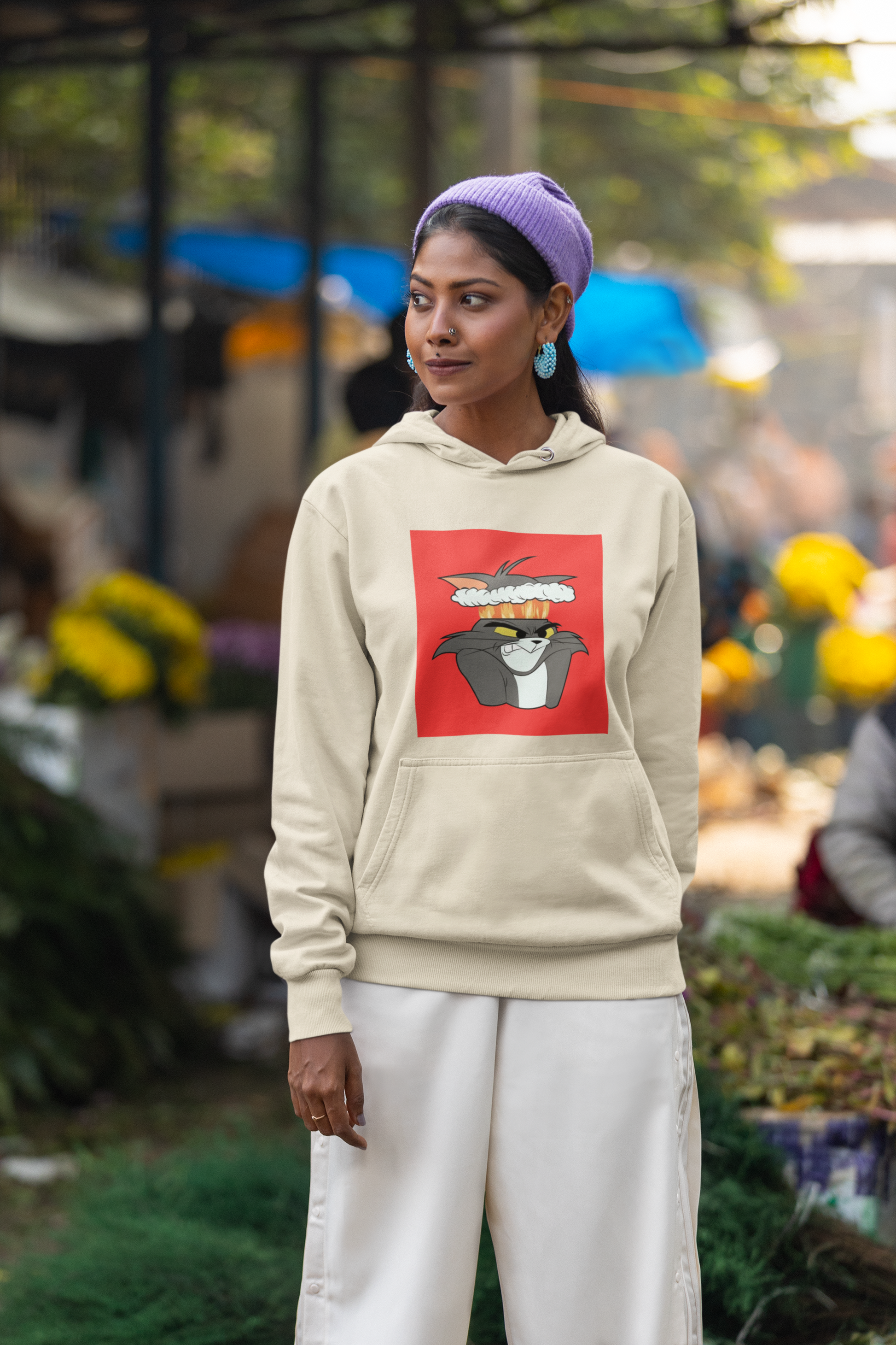 a picture of a woman wearing a beige tom Cartoon from tom and gerry hoodie