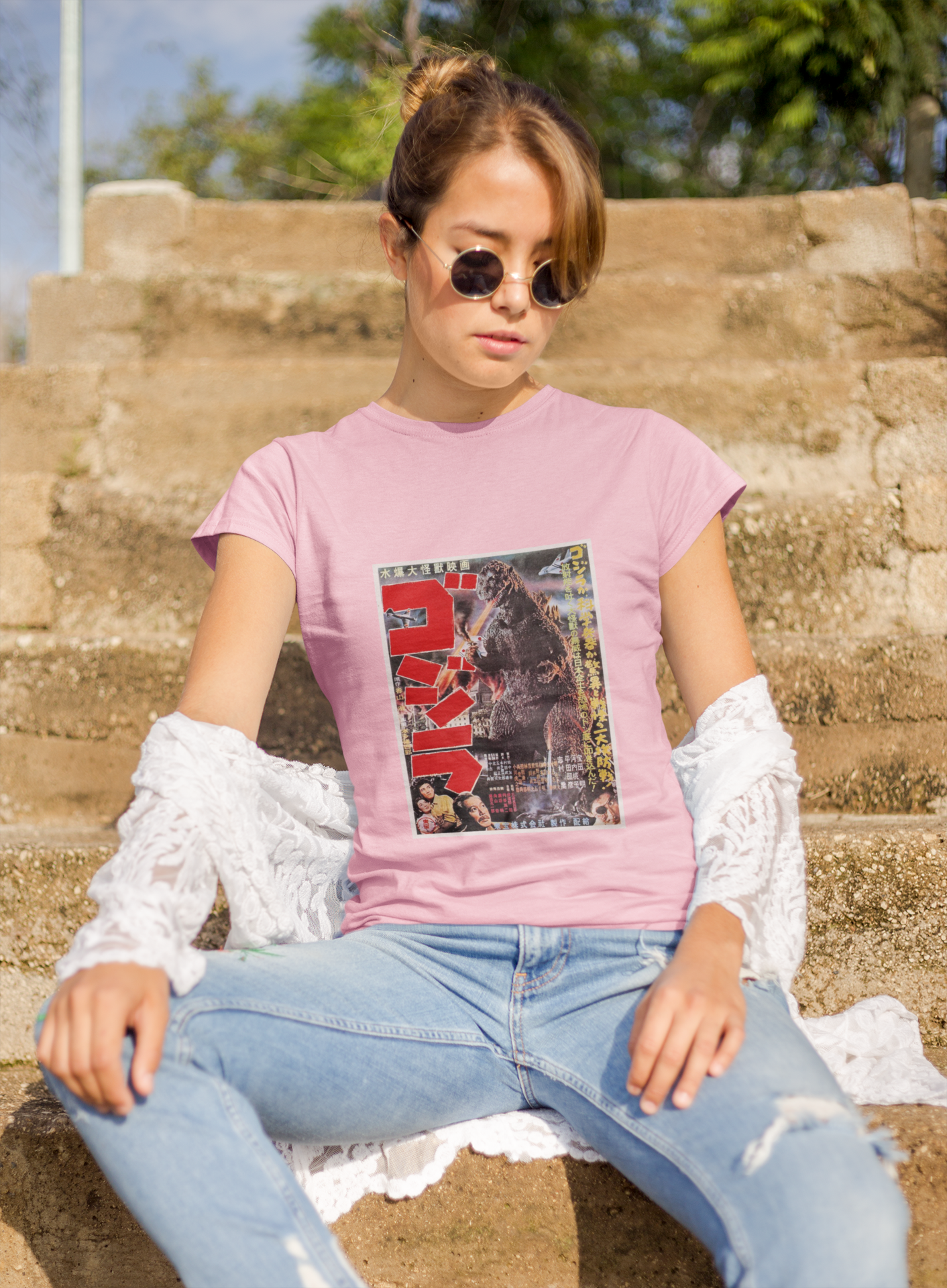 a woman wearing a pink japanese godzilla  t - shirt